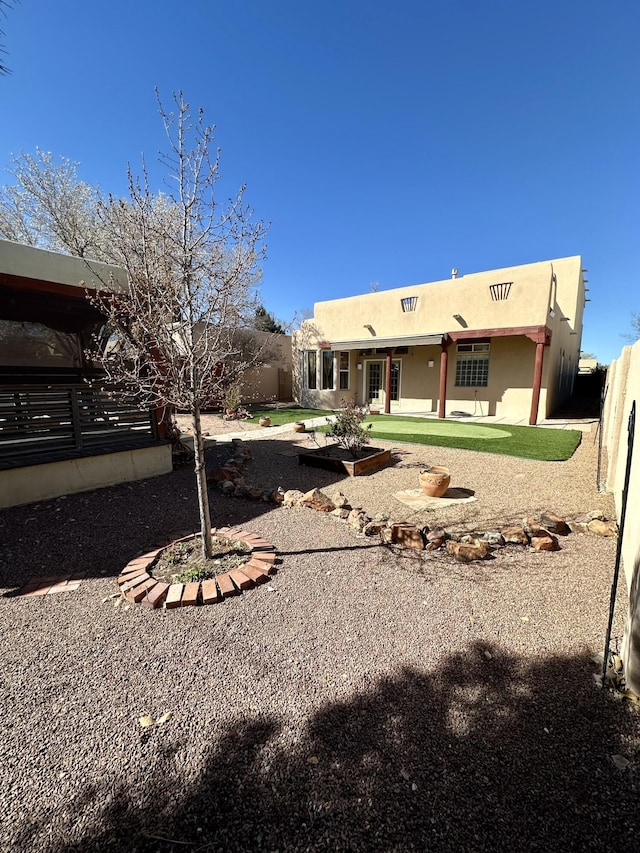 2638 Aloysia Ln NW, Albuquerque, NM 87104 - rear view of property featuring stucco siding and fence