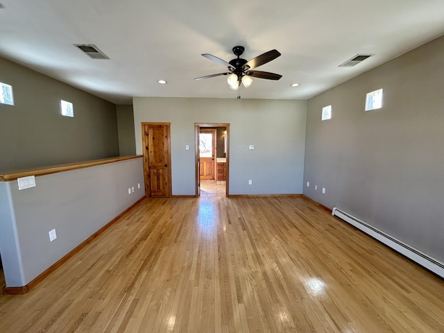 2638 Aloysia Ln NW, Albuquerque, NM 87104 - unfurnished room featuring light wood finished floors, visible vents, ceiling fan, and a baseboard radiator