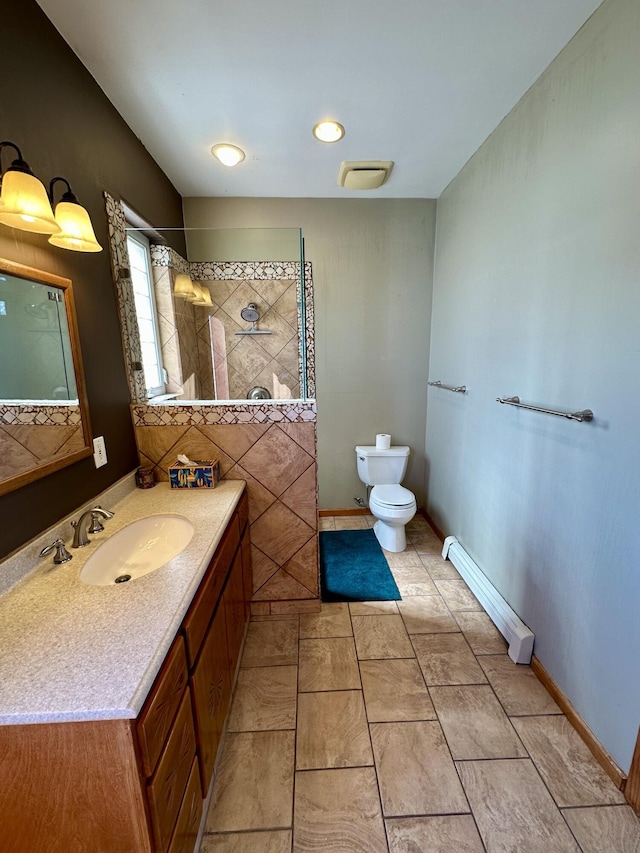 2638 Aloysia Ln NW, Albuquerque, NM 87104 - full bathroom featuring toilet, baseboards, baseboard heating, walk in shower, and vanity