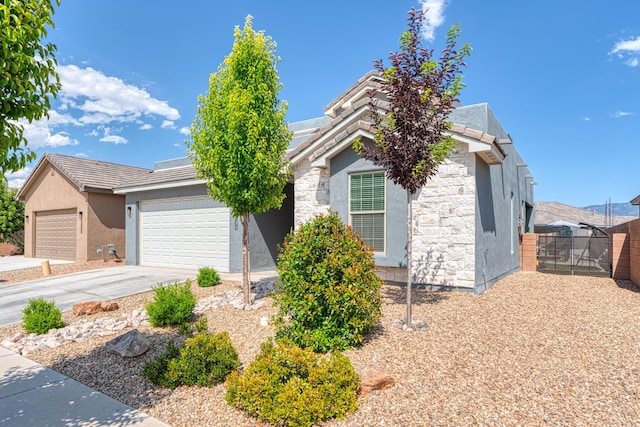 7754 Majesty Ct NW, Albuquerque, NM 87107 - view of front facade with stucco siding, an attached garage, driveway, and stone siding