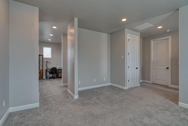 empty room featuring carpet flooring, baseboards, and recessed lighting