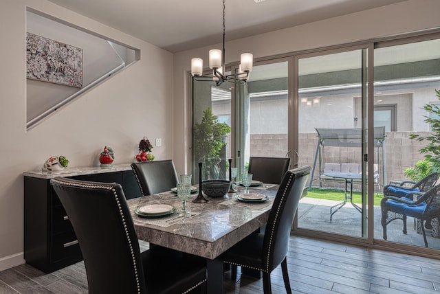 7754 Majesty Ct NW, Albuquerque, NM 87107 - dining area featuring wood finished floors, a chandelier, and baseboards
