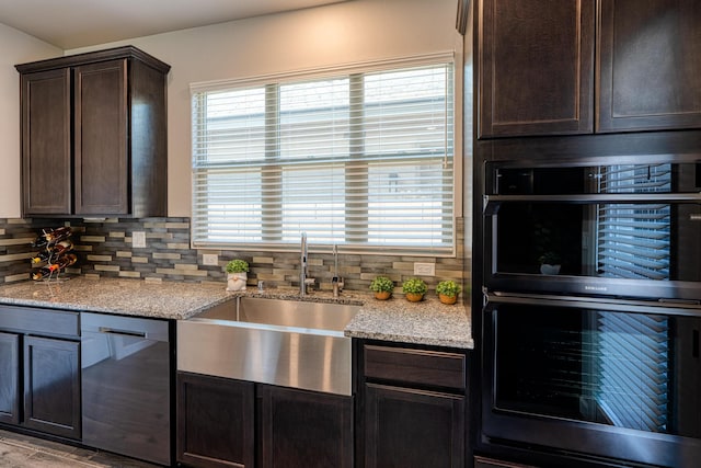 7754 Majesty Ct NW, Albuquerque, NM 87107 - kitchen featuring a sink, stainless steel dishwasher, double wall oven, dark brown cabinetry, and backsplash