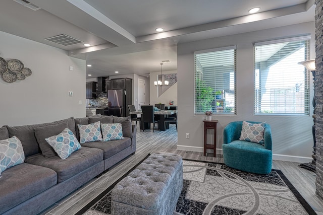 7754 Majesty Ct NW, Albuquerque, NM 87107 - living area with wood finished floors, a chandelier, recessed lighting, and baseboards