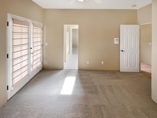 empty room with carpet flooring and a ceiling fan