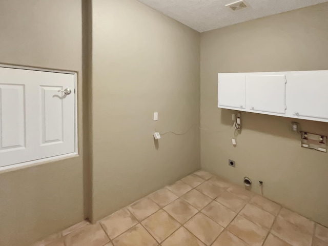clothes washing area with visible vents, hookup for a gas dryer, cabinet space, light tile patterned floors, and hookup for an electric dryer
