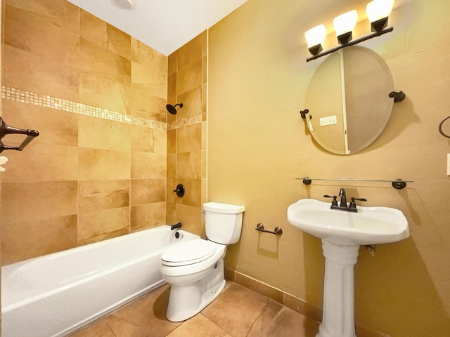 full bathroom featuring tile patterned flooring, toilet,  shower combination, and baseboards