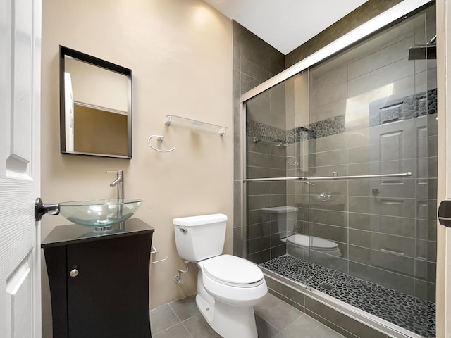 full bathroom with tile patterned flooring, a stall shower, toilet, and vanity