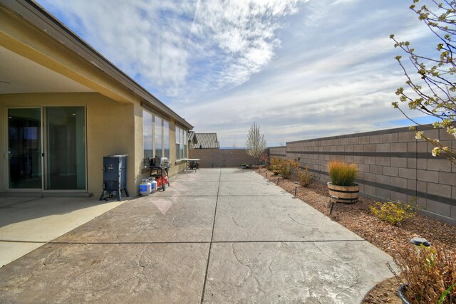 12136 Bear Valley Ln NW, Albuquerque, NM 87120 - fenced backyard featuring a patio area