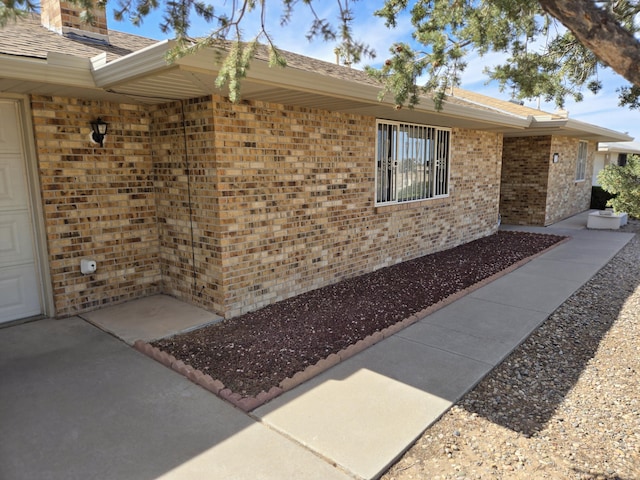 view of side of home with brick siding