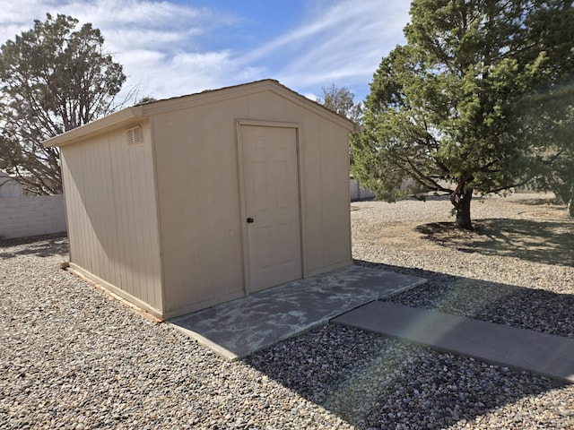 view of shed featuring fence