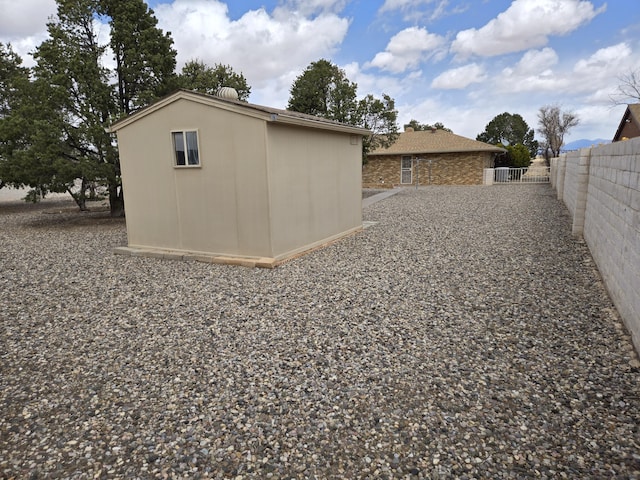 view of shed featuring fence