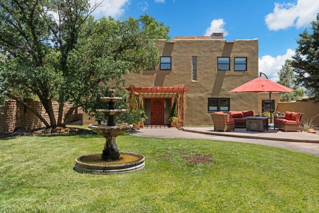 240 E Valverde Rd, Corrales, NM 87048 - back of property with stucco siding, a pergola, a patio area, a fire pit, and a lawn