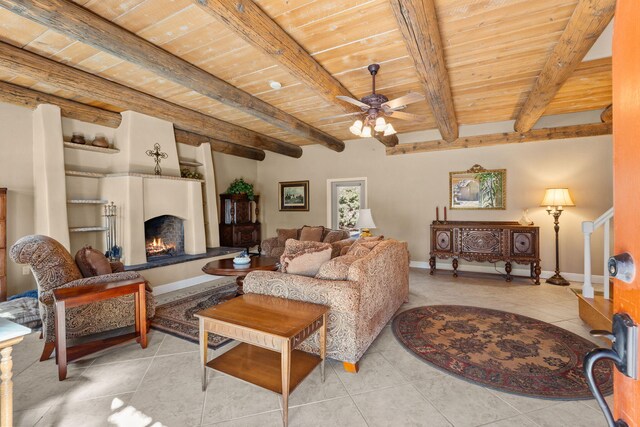 240 E Valverde Rd, Corrales, NM 87048 - living room with inlaid floor details, a wood ceiling with exposed beams, light tile patterned floors, and a ceiling fan