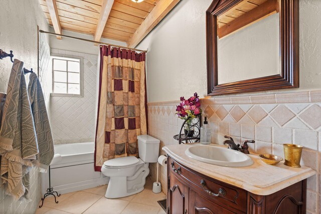 240 E Valverde Rd, Corrales, NM 87048 - kitchen with a wooden ceiling with exposed beams, stainless steel appliances, light wood-style floors, a breakfast bar area, and light brown cabinetry