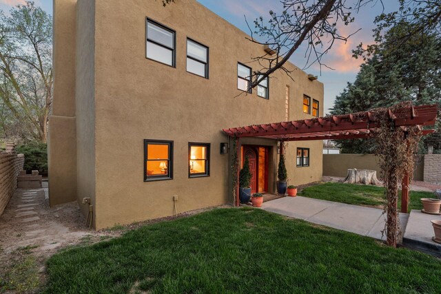 240 E Valverde Rd, Corrales, NM 87048 - rear view of house featuring stucco siding and a patio area