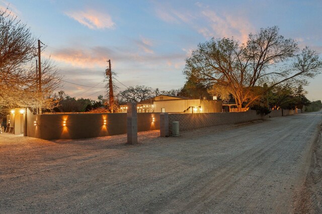 240 E Valverde Rd, Corrales, NM 87048 - view of front facade featuring stucco siding, a fenced backyard, a pergola, and a patio area