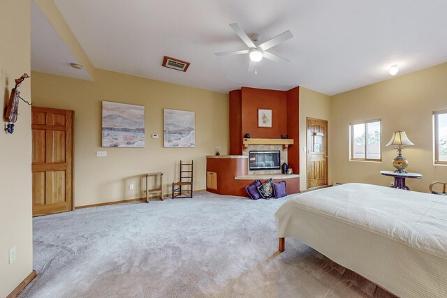 712 Navarra Way SE, Albuquerque, NM 87123 - carpeted bedroom with a glass covered fireplace, baseboards, and ceiling fan
