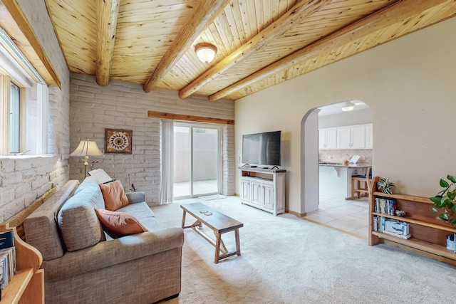 712 Navarra Way SE, Albuquerque, NM 87123 - living room featuring arched walkways, wooden ceiling with exposed beams, and light colored carpet