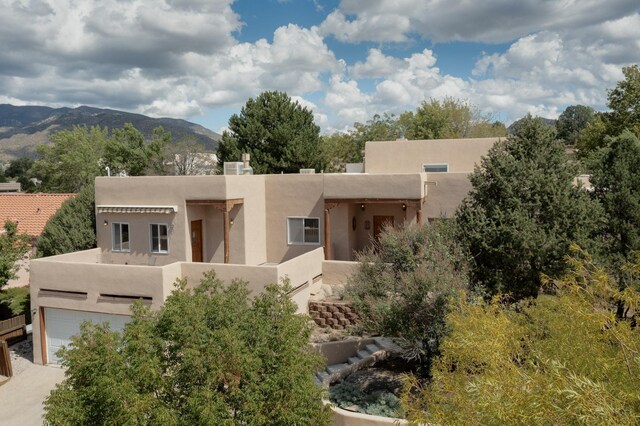 712 Navarra Way SE, Albuquerque, NM 87123 - pueblo-style house featuring stucco siding and a mountain view
