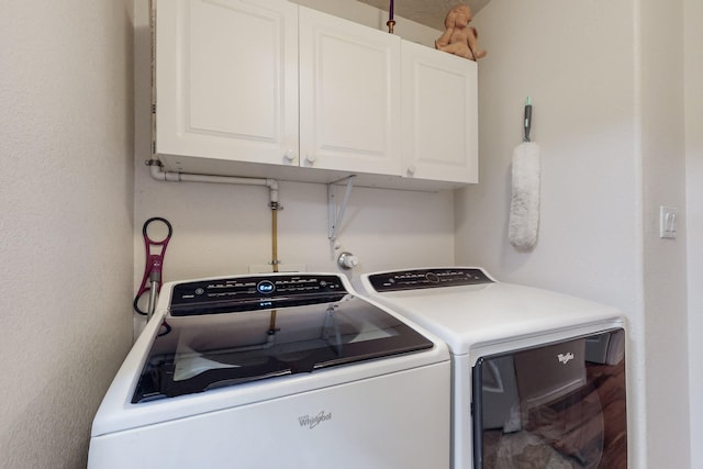 washroom featuring cabinet space and independent washer and dryer