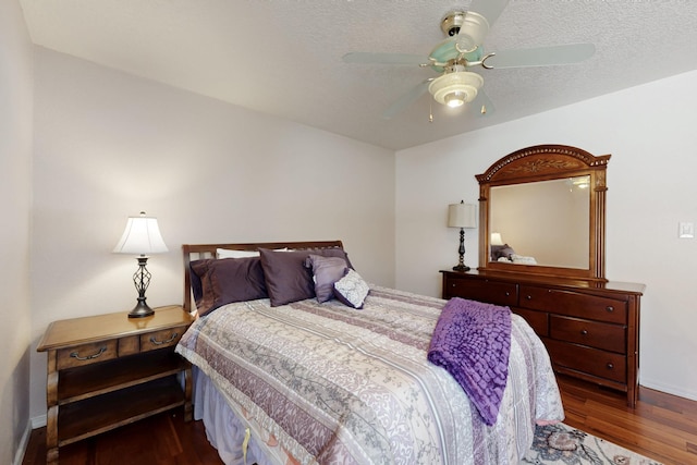 bedroom featuring baseboards, a textured ceiling, ceiling fan, and wood finished floors