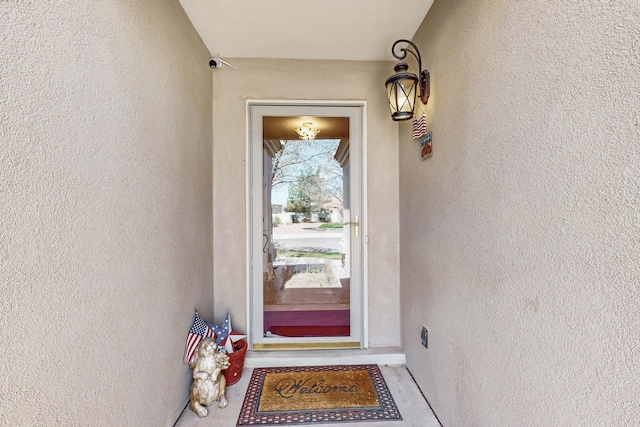 property entrance featuring stucco siding