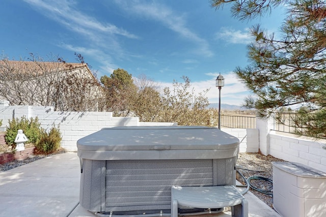 view of patio featuring a fenced backyard and a hot tub