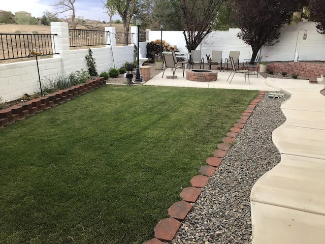 view of yard with a patio, a fire pit, and a fenced backyard