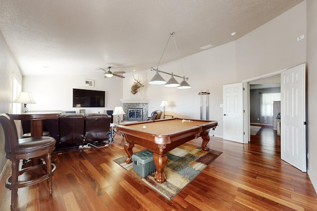 game room featuring ceiling fan, pool table, hardwood / wood-style flooring, and a fireplace