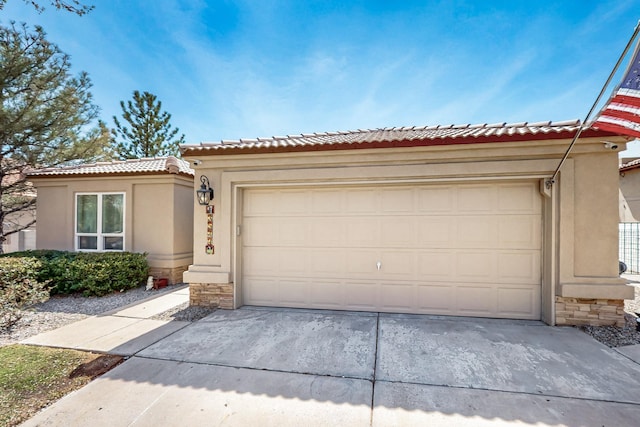 view of front of property with stucco siding, concrete driveway, and stone siding