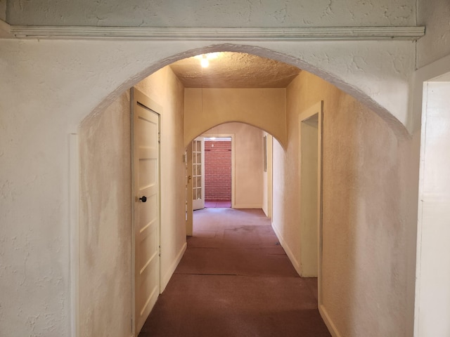 912 Camino Del Pueblo, Bernalillo, NM 87004 - corridor featuring arched walkways, carpet floors, and a textured wall