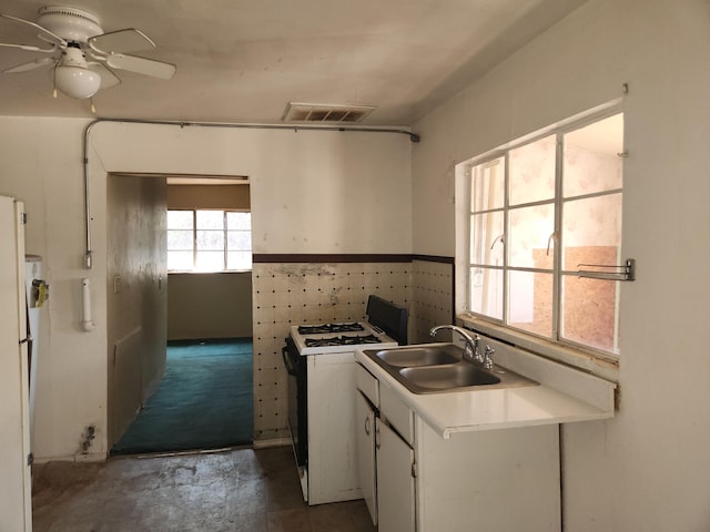 912 Camino Del Pueblo, Bernalillo, NM 87004 - kitchen with white appliances, visible vents, ceiling fan, a sink, and white cabinetry