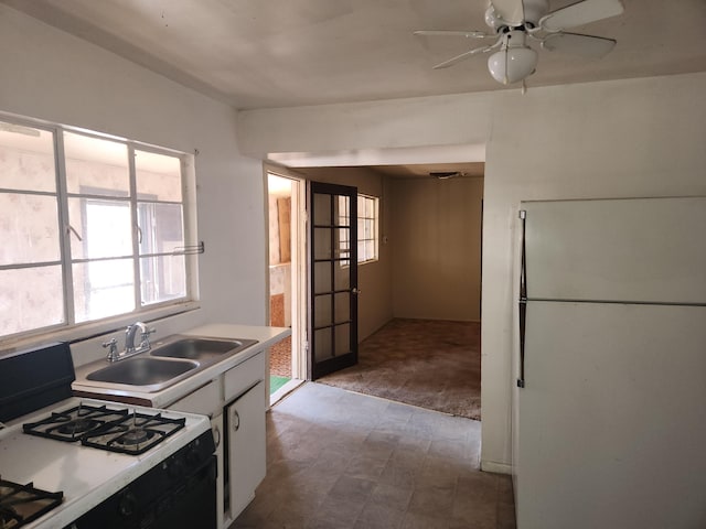 912 Camino Del Pueblo, Bernalillo, NM 87004 - kitchen featuring tile patterned floors, a ceiling fan, a sink, white cabinetry, and white appliances