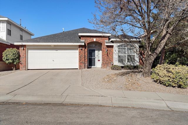 9405 Vervain Dr NW, Albuquerque, NM 87114 - ranch-style house with brick siding, roof with shingles, an attached garage, and concrete driveway