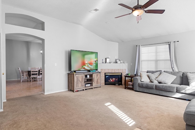 9405 Vervain Dr NW, Albuquerque, NM 87114 - carpeted living room with ceiling fan, a fireplace, arched walkways, visible vents, and vaulted ceiling