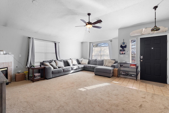 9405 Vervain Dr NW, Albuquerque, NM 87114 - carpeted living room with tile patterned floors, ceiling fan, lofted ceiling, and a textured ceiling