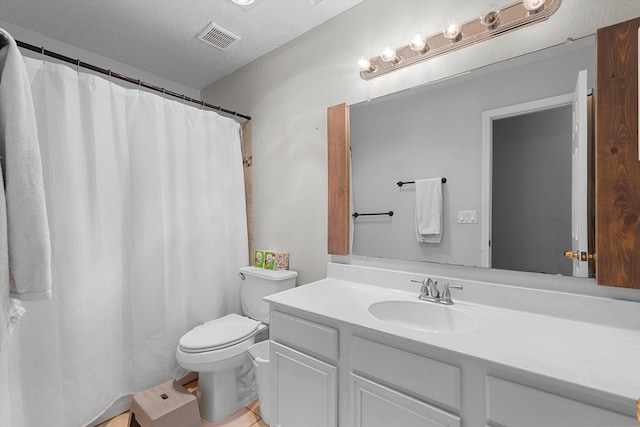 9405 Vervain Dr NW, Albuquerque, NM 87114 - bathroom featuring vanity, tile patterned floors, a textured ceiling, toilet, and visible vents