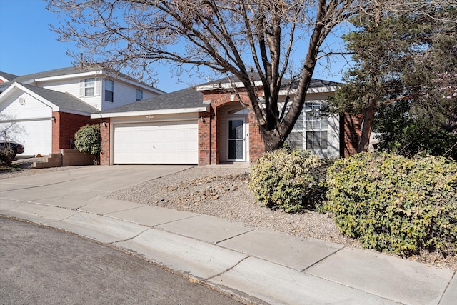 9405 Vervain Dr NW, Albuquerque, NM 87114 - traditional-style house featuring roof with shingles, a garage, concrete driveway, and brick siding
