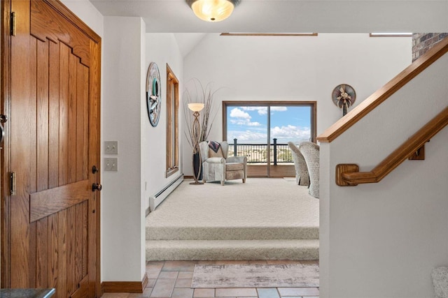 entryway featuring light tile patterned floors, a baseboard radiator, light colored carpet, and stairs