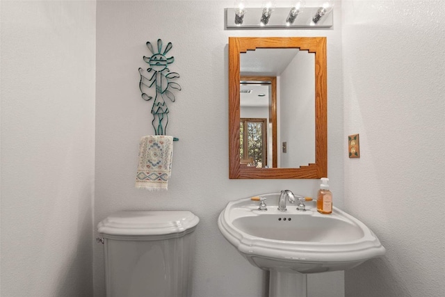 half bathroom with a sink and toilet
