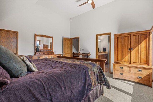 bedroom featuring high vaulted ceiling, light colored carpet, and a ceiling fan