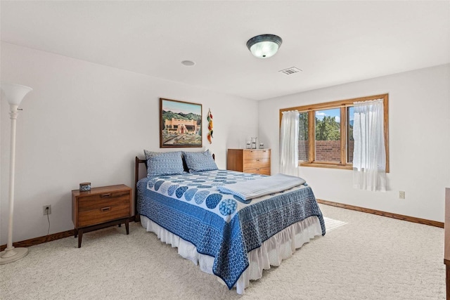 bedroom featuring light carpet, baseboards, and visible vents