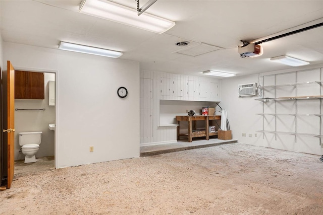 garage featuring a garage door opener, a wall mounted air conditioner, and visible vents