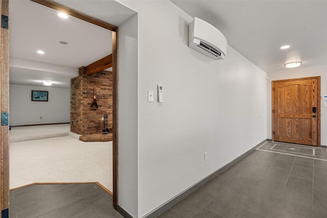 hallway with an AC wall unit, baseboards, and recessed lighting