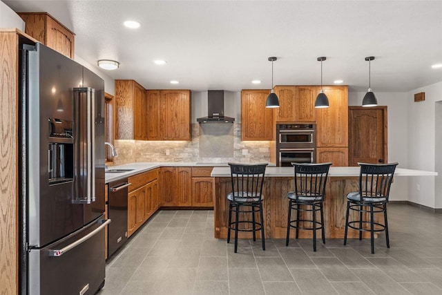 kitchen featuring wall chimney exhaust hood, dishwasher, a sink, double wall oven, and high end fridge
