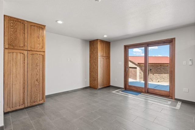 spare room featuring baseboards and recessed lighting