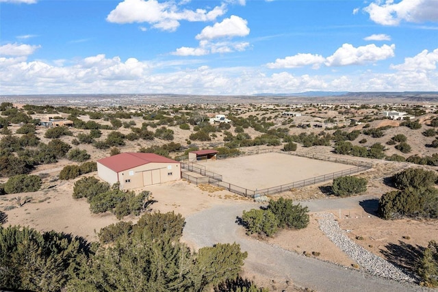 birds eye view of property featuring a rural view and a desert view