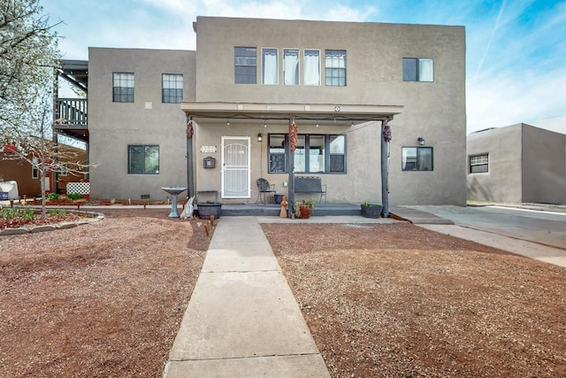 view of front of home featuring a porch and stucco siding