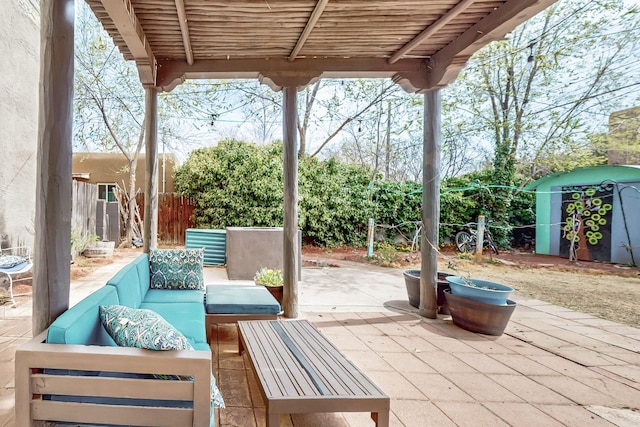 view of patio with a shed, an outdoor living space, an outdoor structure, and fence